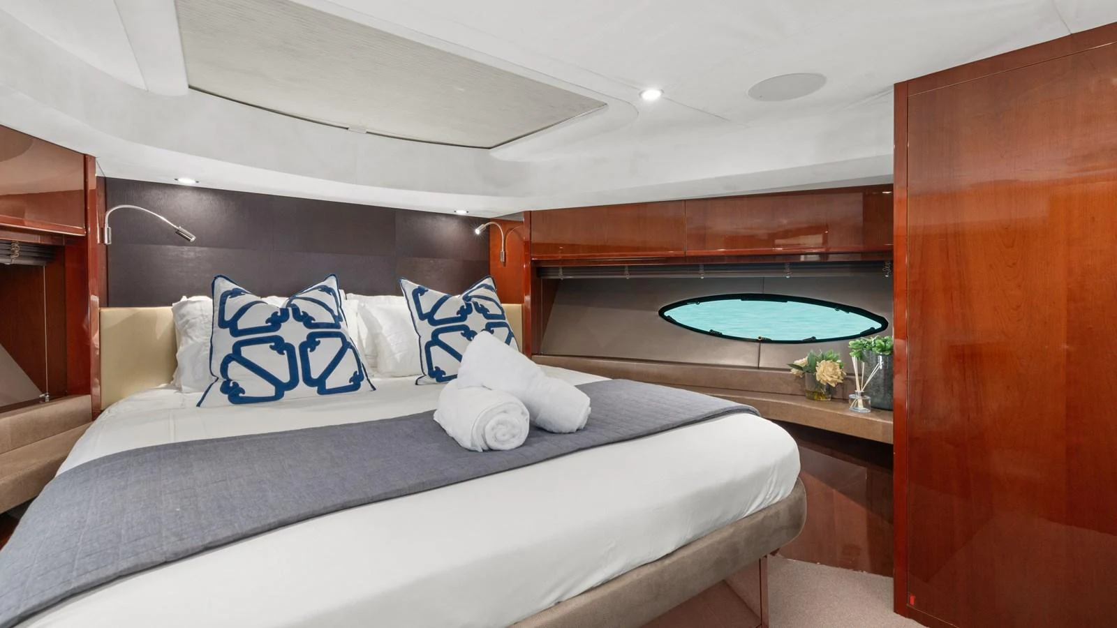 The stateroom features a comfortable bed with elegant bedding and stylish decor. aboard ABOUT TIME Yacht for Sale