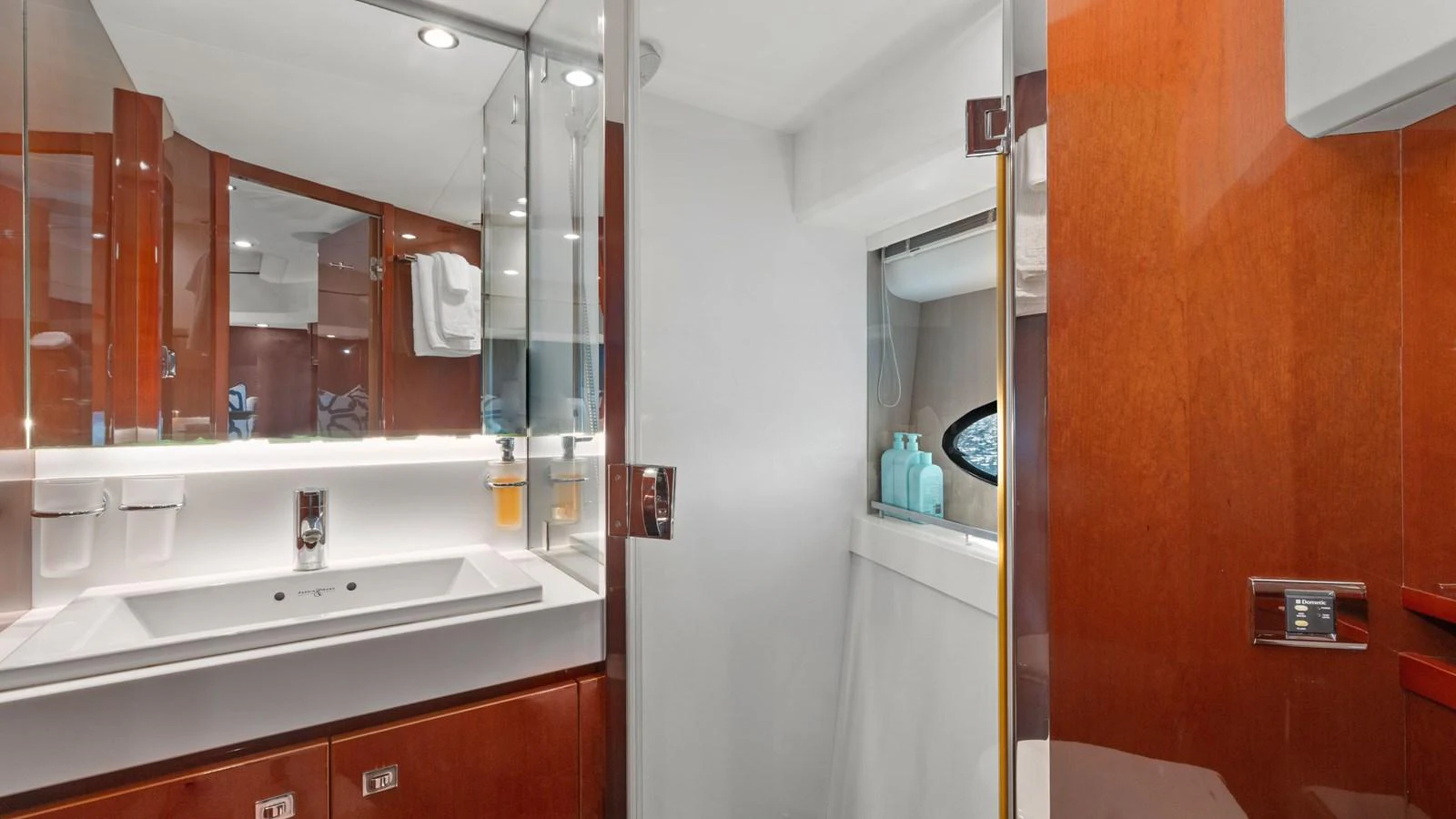 The yacht's bathroom features a sleek design with a modern sink and ample lighting. aboard ABOUT TIME Yacht for Sale