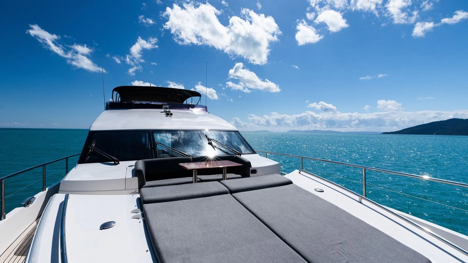 The yacht's bow area features a spacious sunbathing pad with stunning ocean views. aboard ABOUT TIME Yacht for Sale