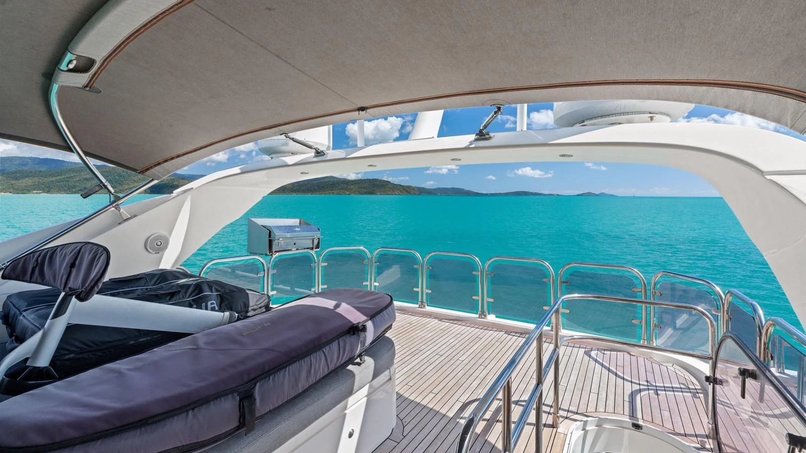 The flybridge offers stunning views of the turquoise waters and surrounding landscape. aboard ABOUT TIME Yacht for Sale