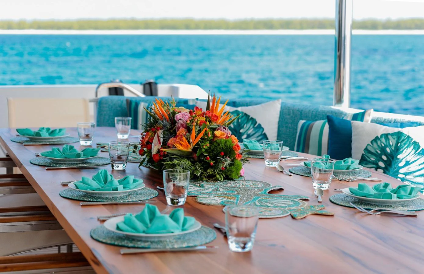 a table set with plates and glasses aboard CUPCAKE Yacht for Sale