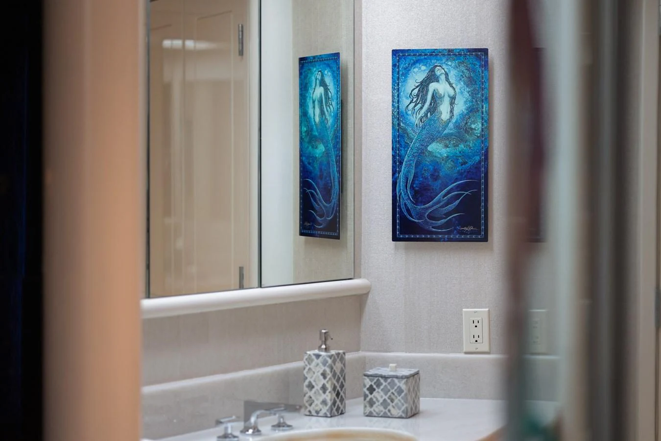 a bathroom with a sink and a painting on the wall aboard CUPCAKE Yacht for Sale