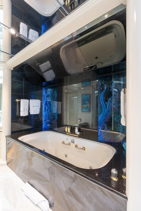 a bathroom with a large mirror aboard CUPCAKE Yacht for Sale