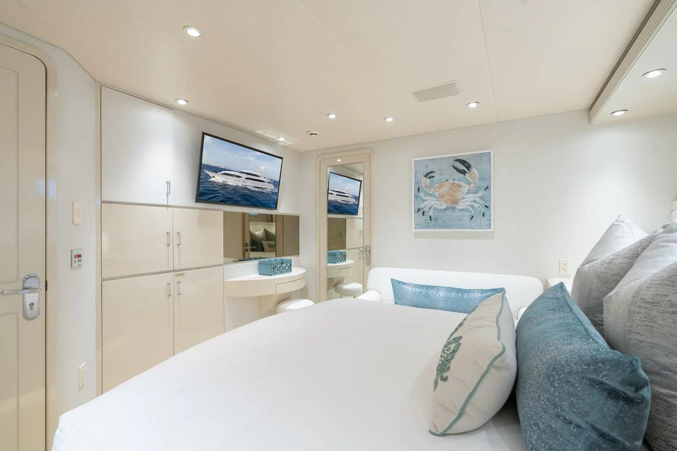 a bedroom with a bed and a tv on the wall aboard CUPCAKE Yacht for Sale