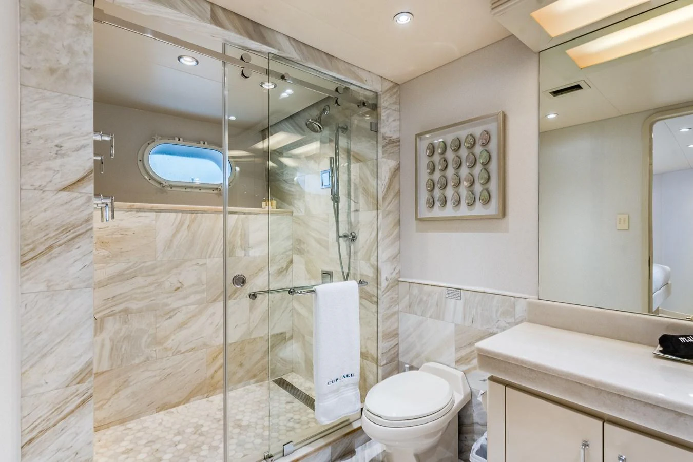 a bathroom with a glass shower aboard CUPCAKE Yacht for Sale