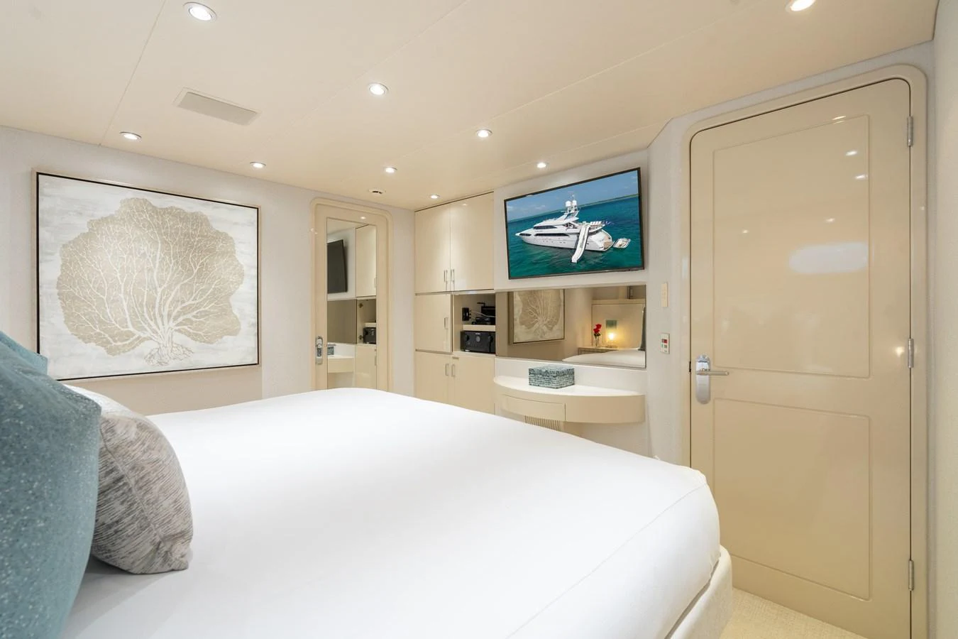 a bedroom with a bed and a television aboard CUPCAKE Yacht for Sale