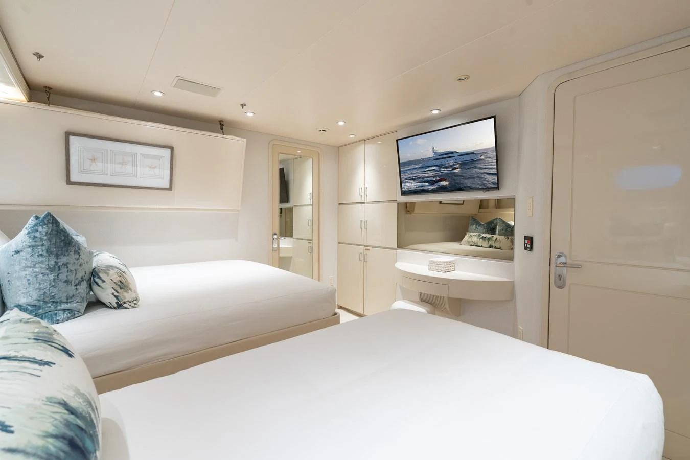 a bedroom with a bed and a television on the wall aboard CUPCAKE Yacht for Sale