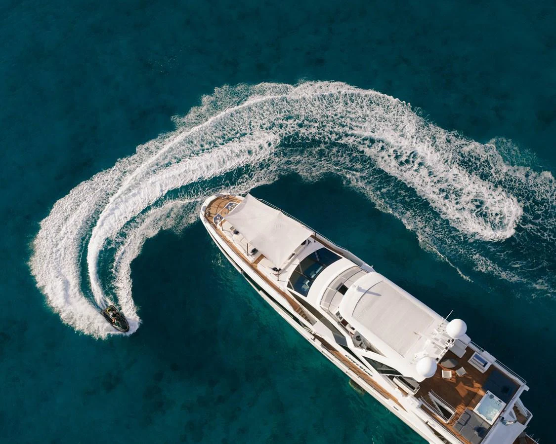 a helicopter flying over a beach aboard CARPE DIEM Yacht for Sale