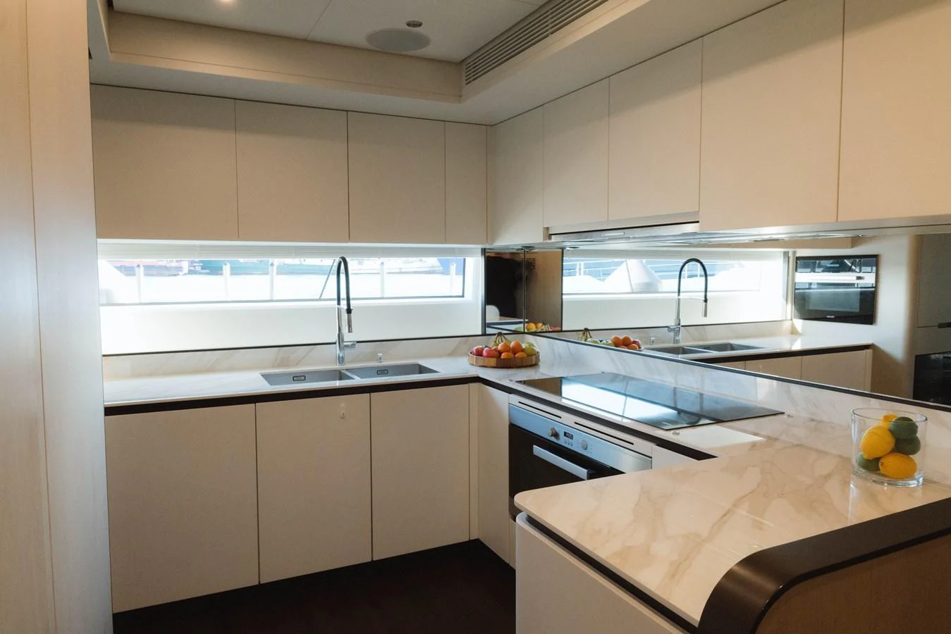 a kitchen with white cabinets aboard CARPE DIEM Yacht for Sale
