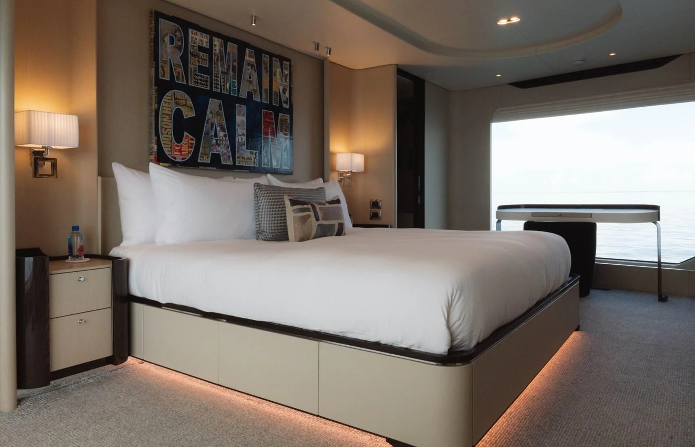 a bedroom with a bed and a table aboard CARPE DIEM Yacht for Sale