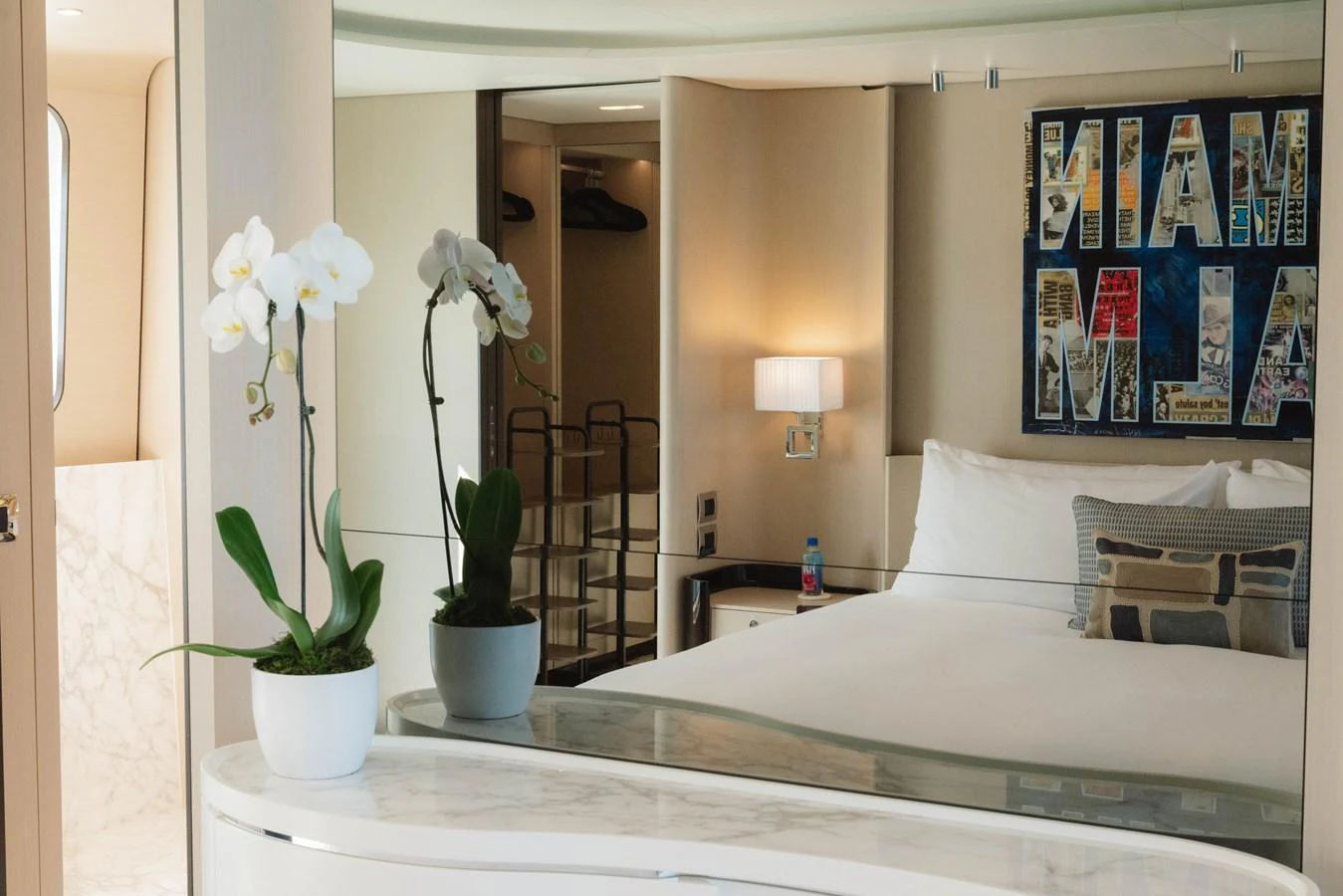 a bed with white sheets and flowers aboard CARPE DIEM Yacht for Sale
