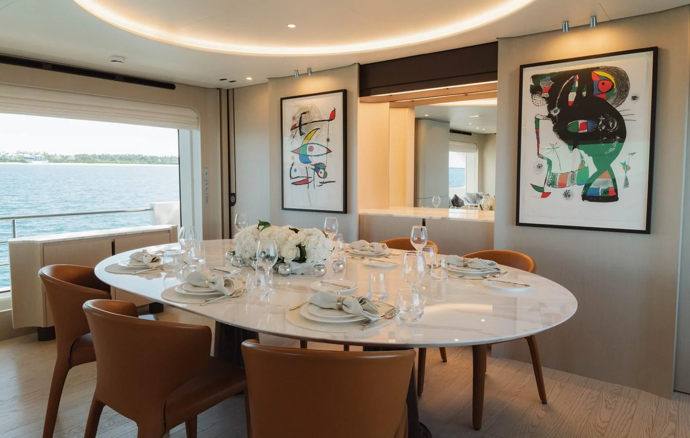 a dining table with a vase of flowers on it aboard CARPE DIEM Yacht for Sale