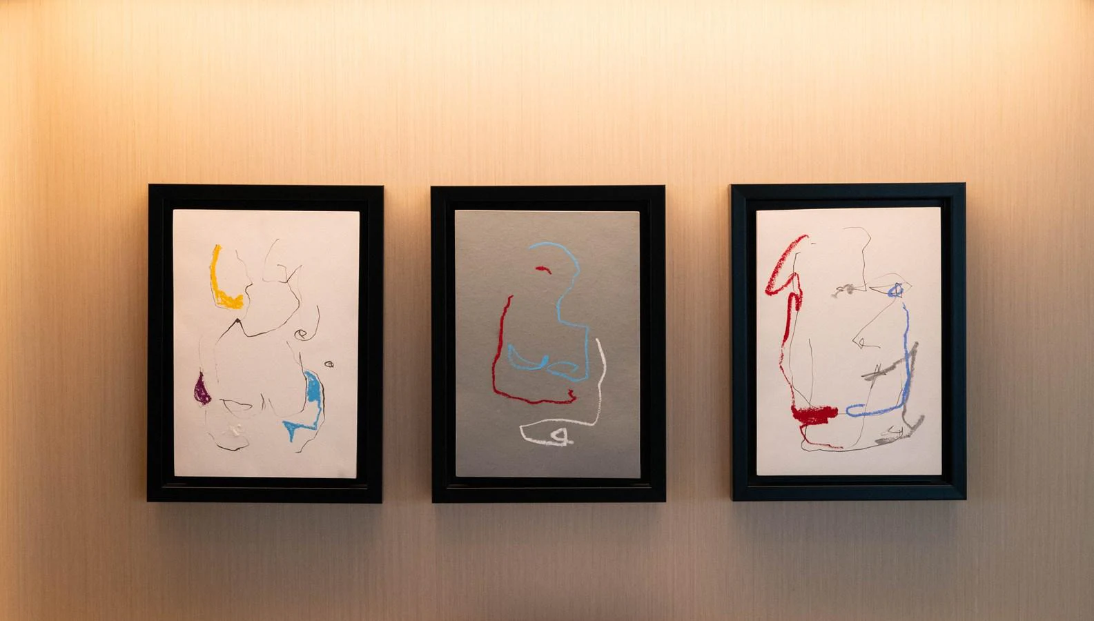 a group of framed pictures on a wall aboard CARPE DIEM Yacht for Sale