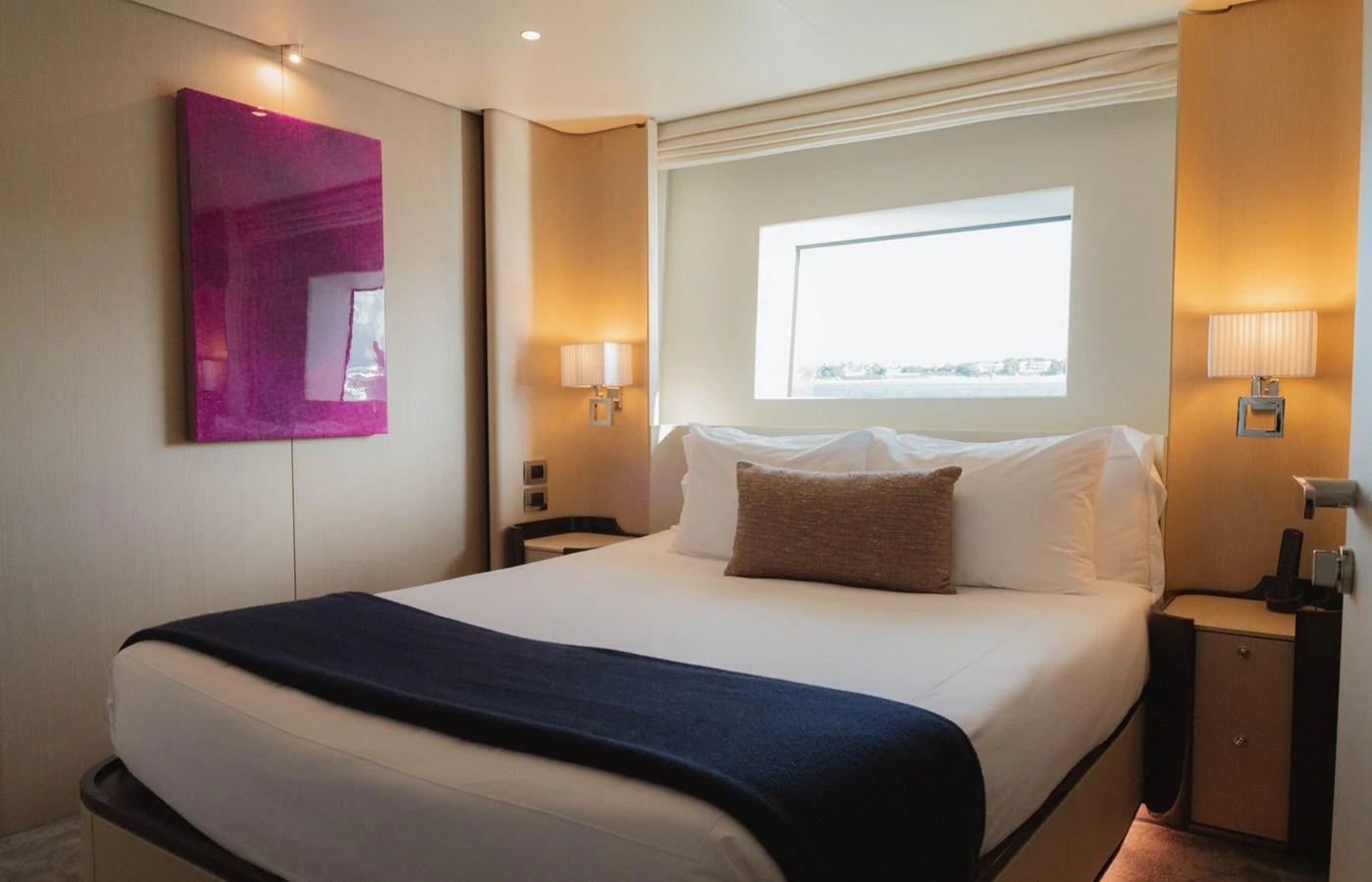 a bed with a white bed spread aboard CARPE DIEM Yacht for Sale