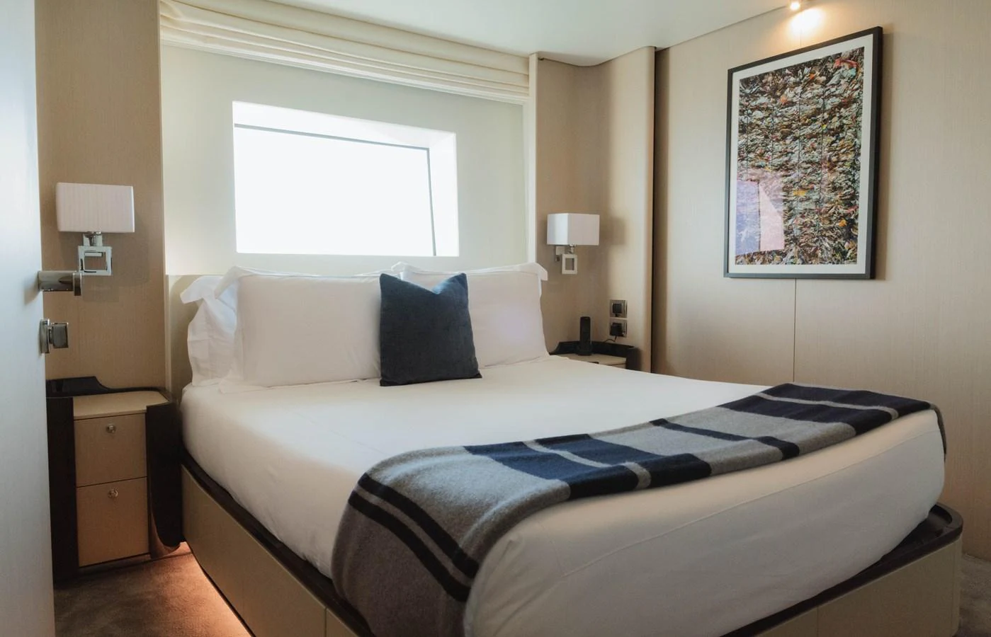 a bed with a blue and white blanket on it aboard CARPE DIEM Yacht for Sale