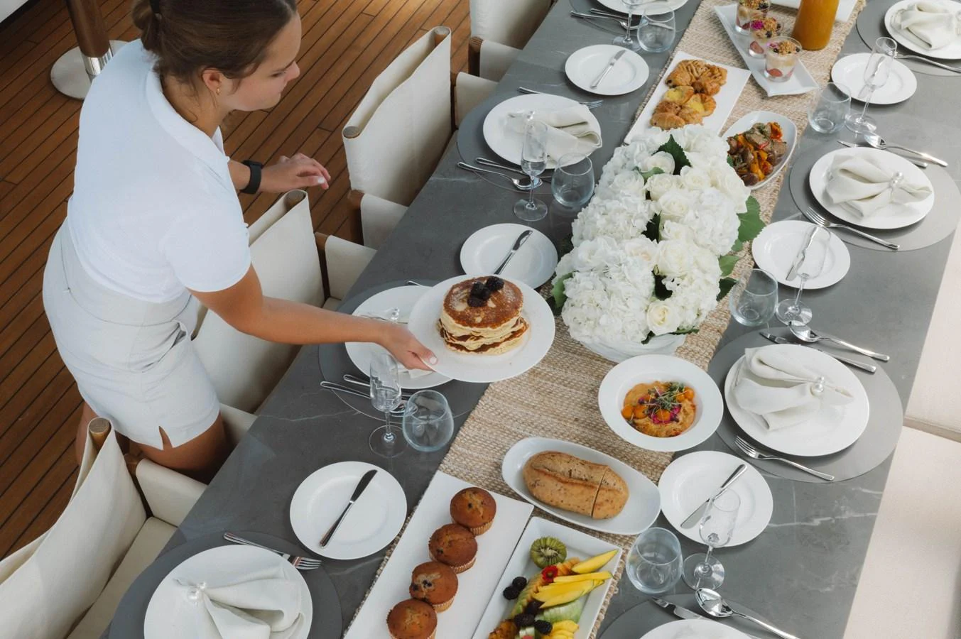 a person pouring a drink into a glass aboard CARPE DIEM Yacht for Sale