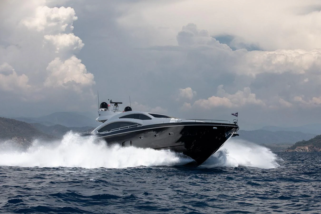 A sleek yacht cuts through the waves, showcasing its powerful performance on open waters. aboard AMARA Yacht for Sale