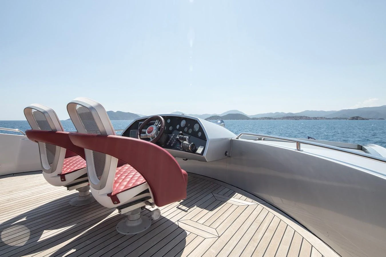 The yacht's helm features sleek, modern design with comfortable seating and a panoramic view of the sea. aboard AMARA Yacht for Sale