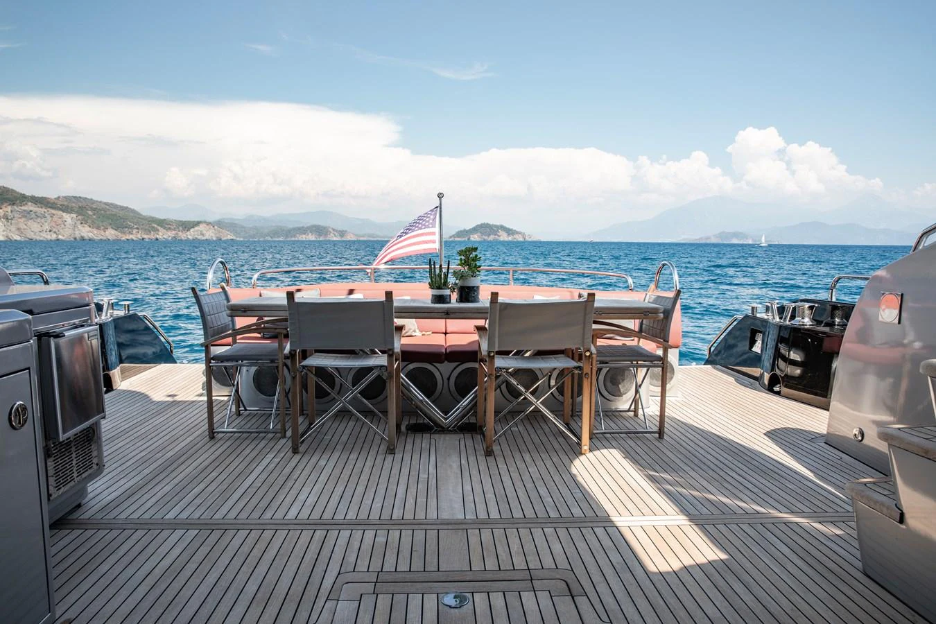 The aft deck features an elegant dining area with a stunning ocean view. aboard AMARA Yacht for Sale
