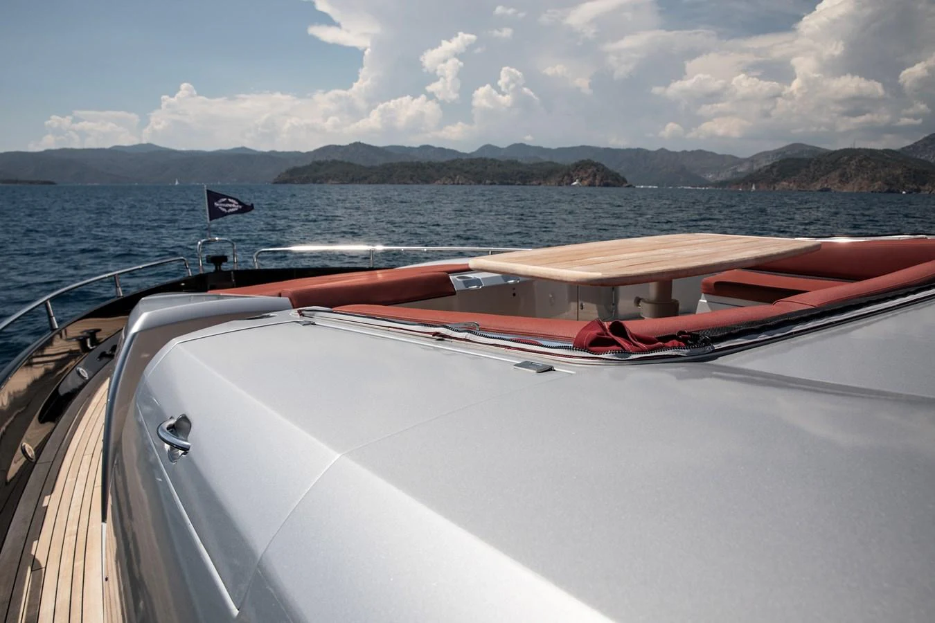 The yacht's foredeck features a sleek design with a spacious lounging area and a beautiful view of the sea. aboard AMARA Yacht for Sale