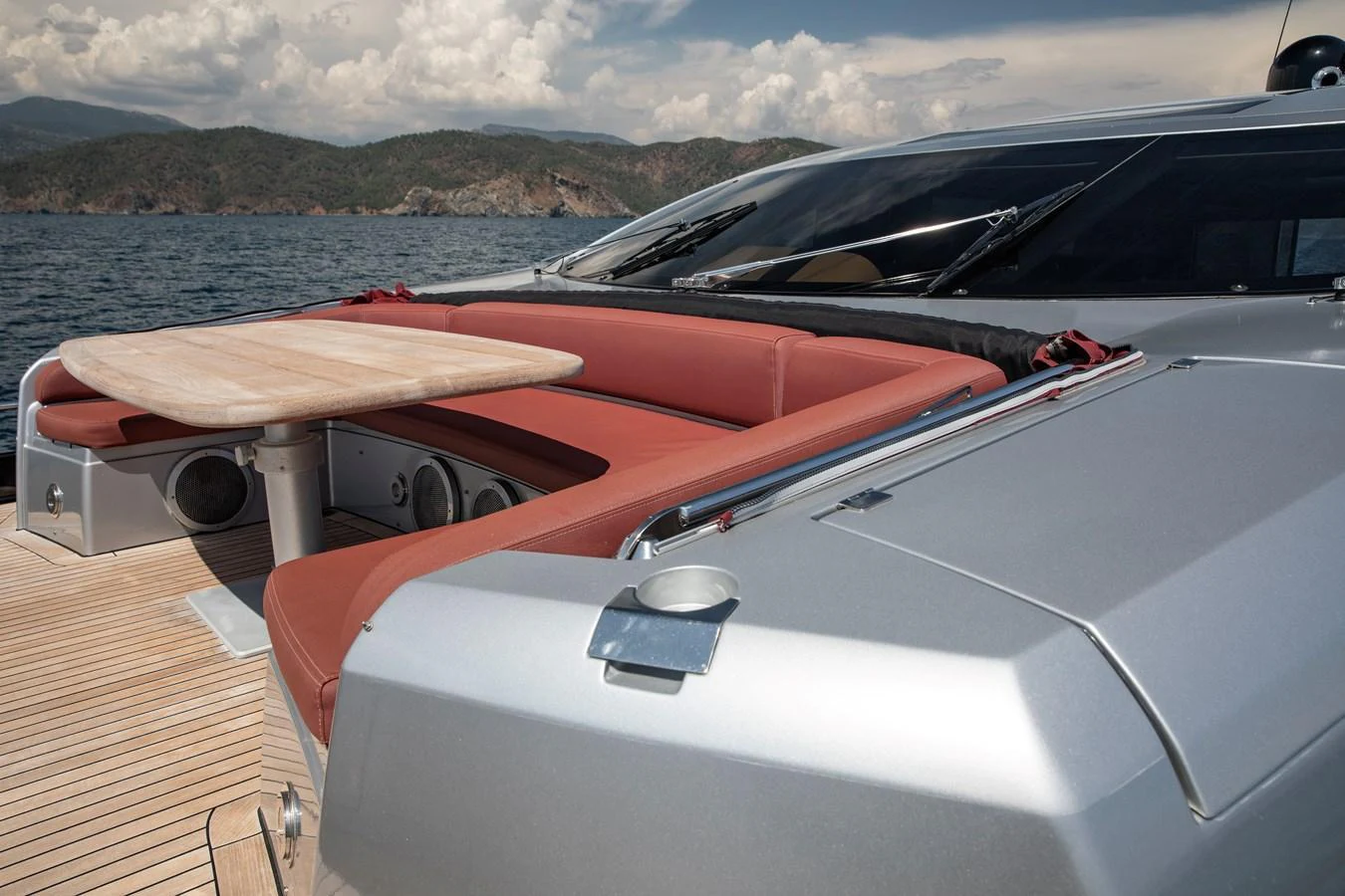 The foredeck features a stylish seating area with a wooden table, perfect for enjoying the view. aboard AMARA Yacht for Sale