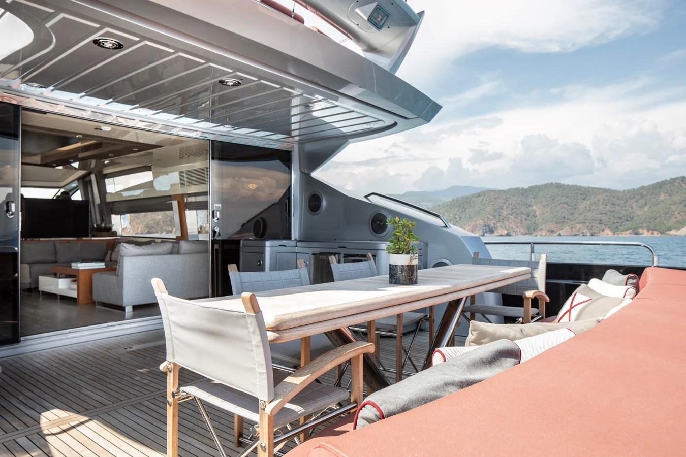 The aft deck features a spacious outdoor dining area with comfortable seating and stunning views. aboard AMARA Yacht for Sale