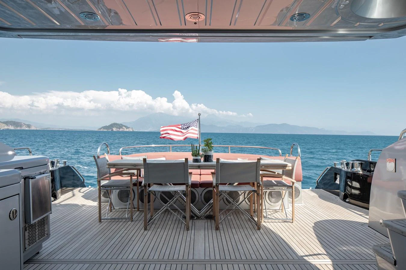 The aft deck features an elegant dining area with stunning ocean views. aboard AMARA Yacht for Sale