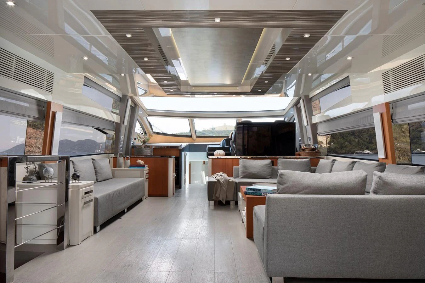 The spacious salon features modern furnishings and large windows for panoramic views. aboard AMARA Yacht for Sale