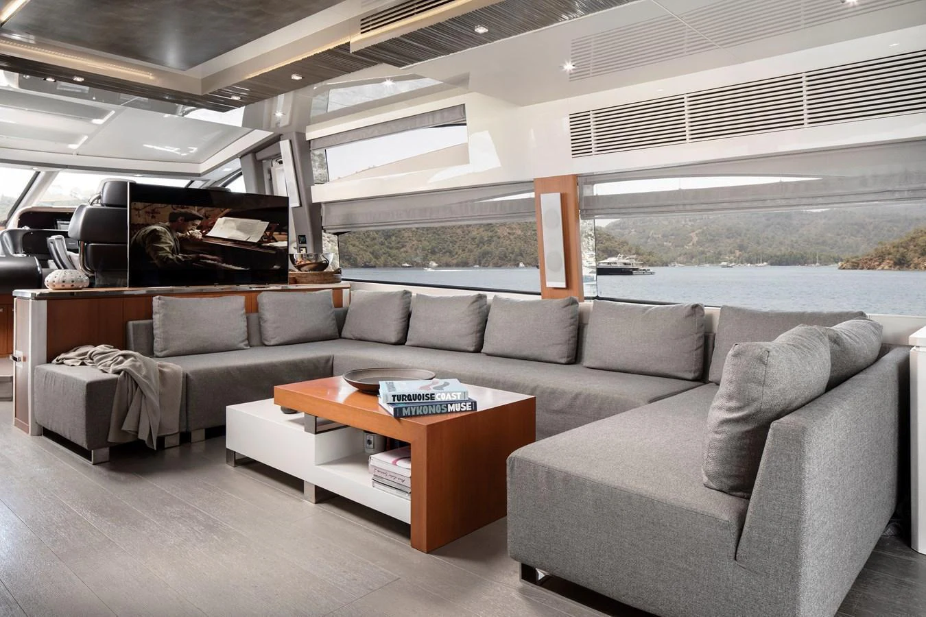 The salon features a spacious and modern seating area with panoramic windows offering stunning views. aboard AMARA Yacht for Sale