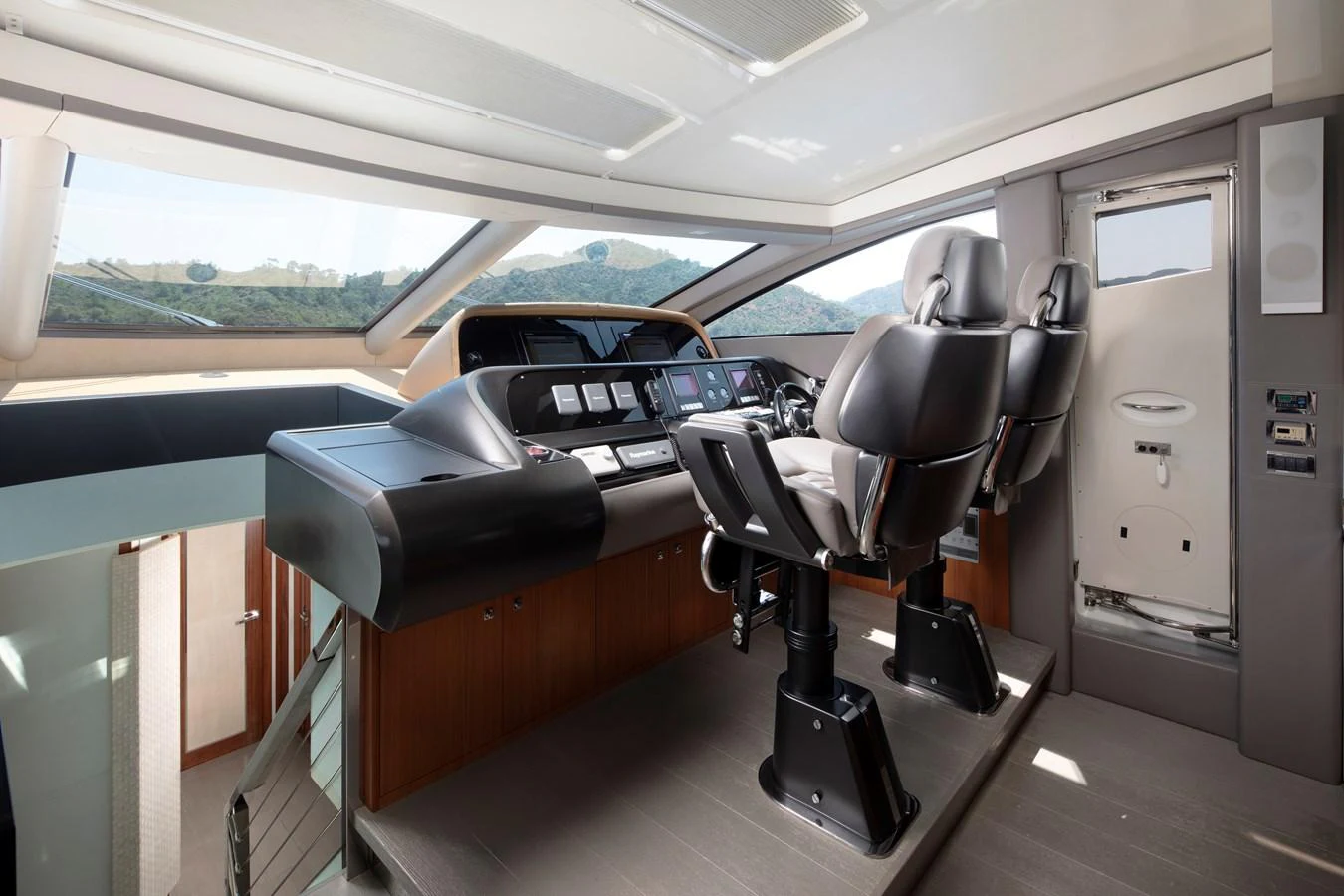 The helm station features modern navigation equipment and comfortable seating with panoramic views. aboard AMARA Yacht for Sale