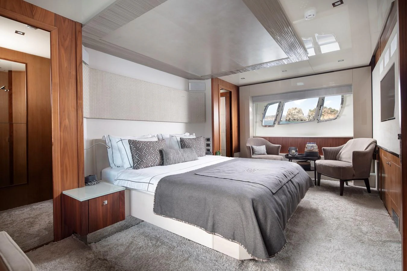 The master stateroom features a luxurious bed with elegant decor and ample natural light. aboard AMARA Yacht for Sale