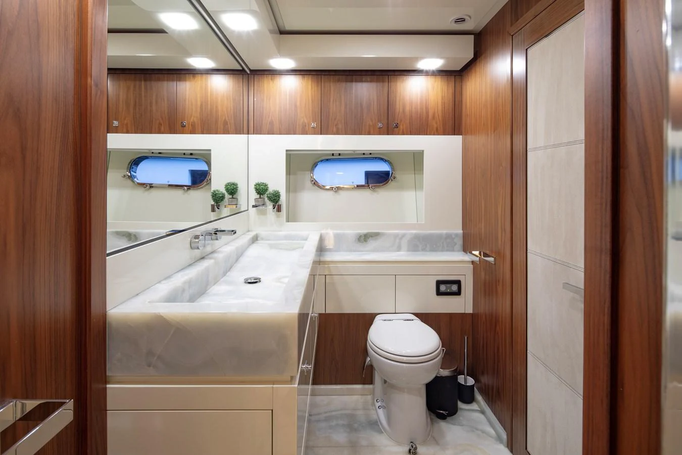 This elegant yacht bathroom features luxurious wood paneling and modern fixtures. aboard AMARA Yacht for Sale