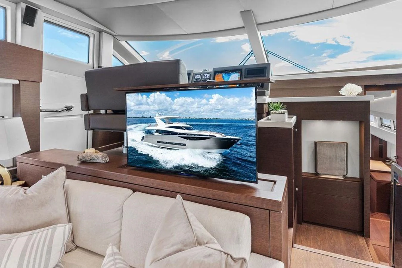 a living room with a large television aboard ELEVATION Yacht for Sale