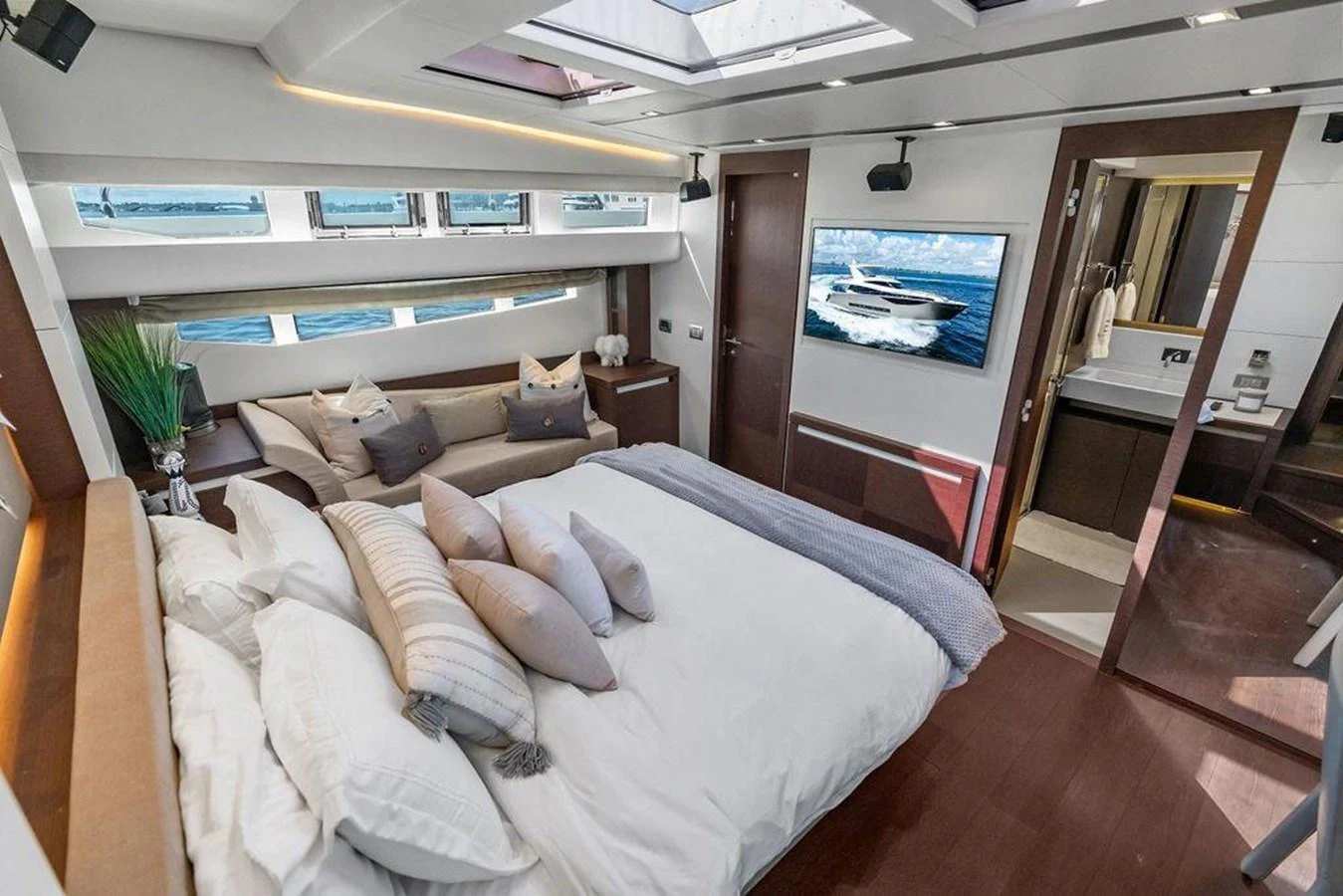 a bedroom with a bed and a desk aboard ELEVATION Yacht for Sale