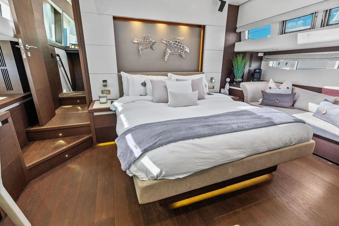 a bedroom with a bed and a couch aboard ELEVATION Yacht for Sale