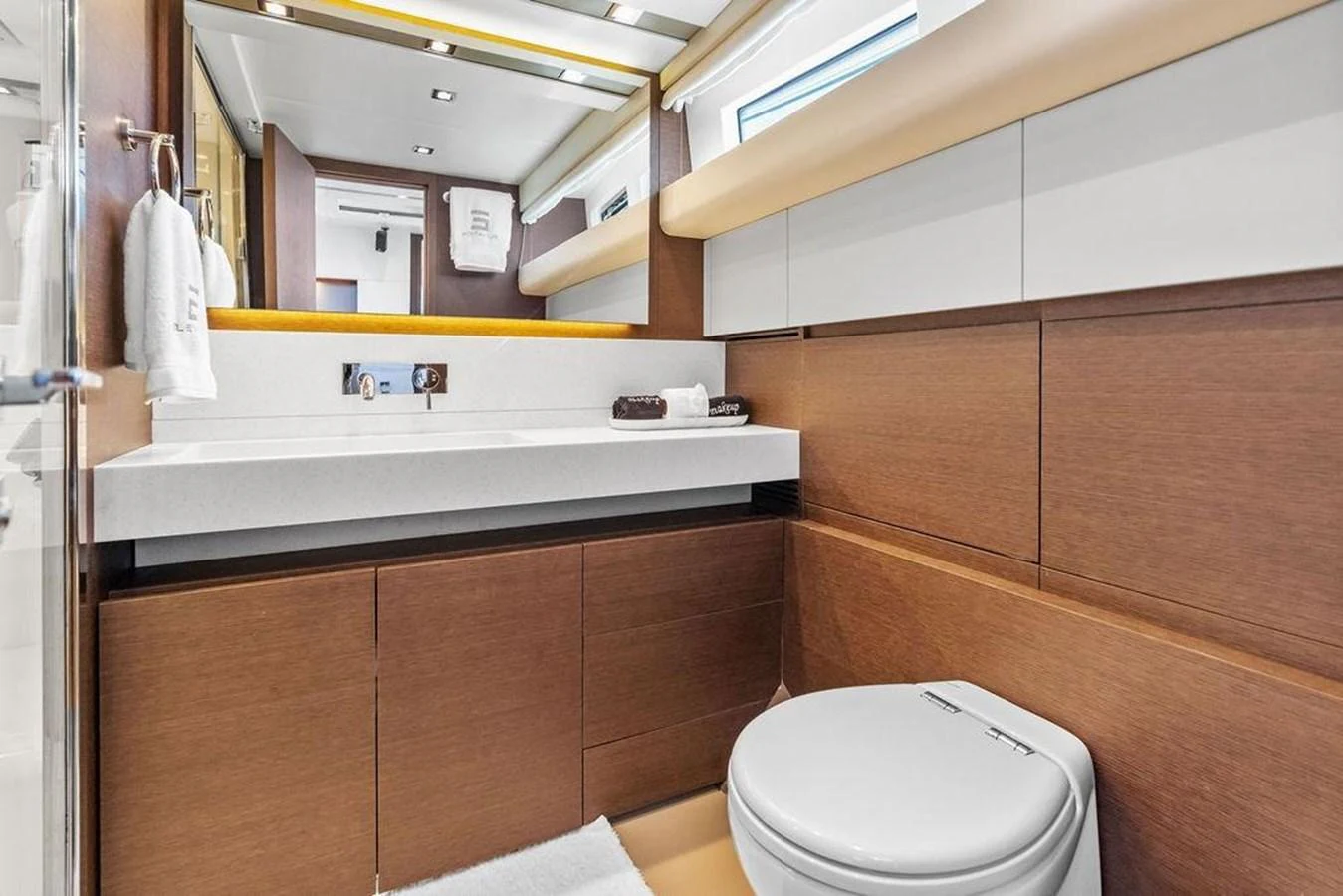 a bathroom with a toilet and a mirror aboard ELEVATION Yacht for Sale
