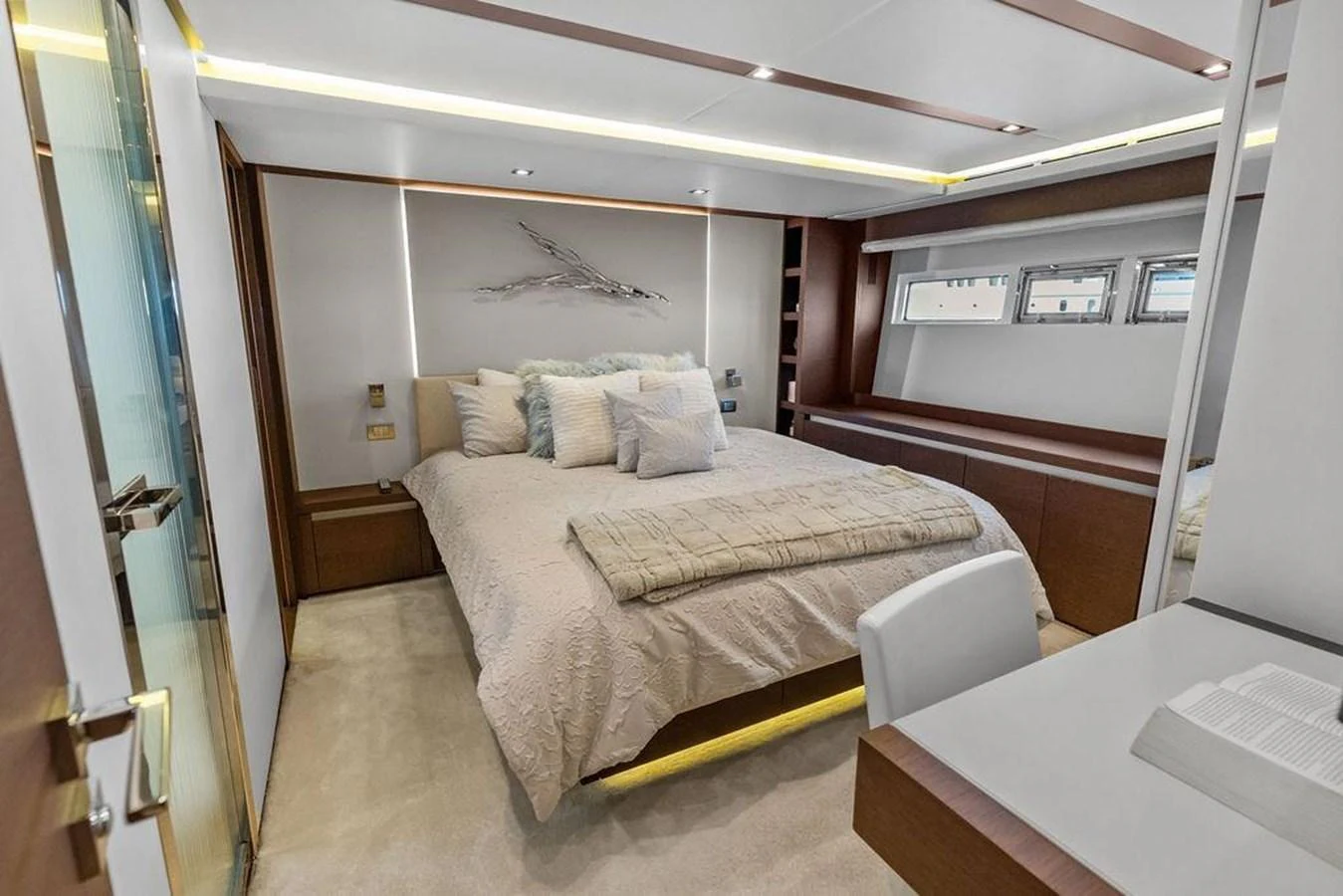 a bedroom with a bed and desk aboard ELEVATION Yacht for Sale