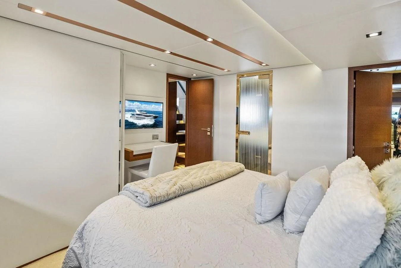 a bedroom with a bed and a television aboard ELEVATION Yacht for Sale