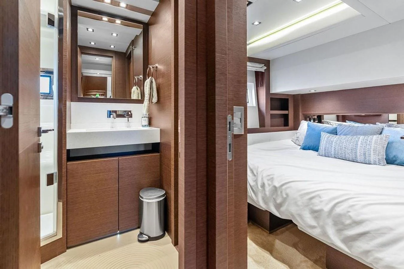 a bedroom with a bed and a mirror aboard ELEVATION Yacht for Sale