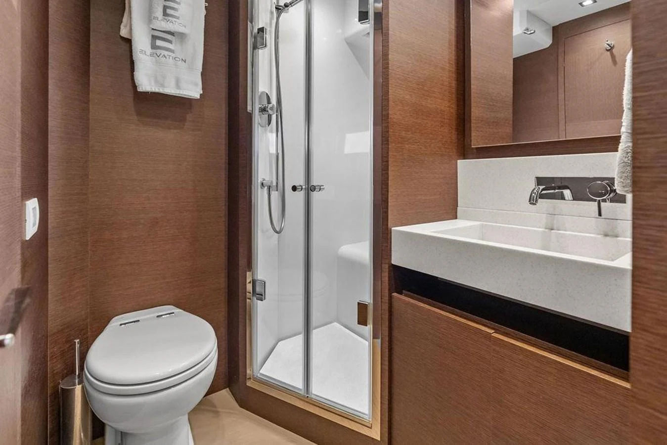 a bathroom with a glass shower door aboard ELEVATION Yacht for Sale