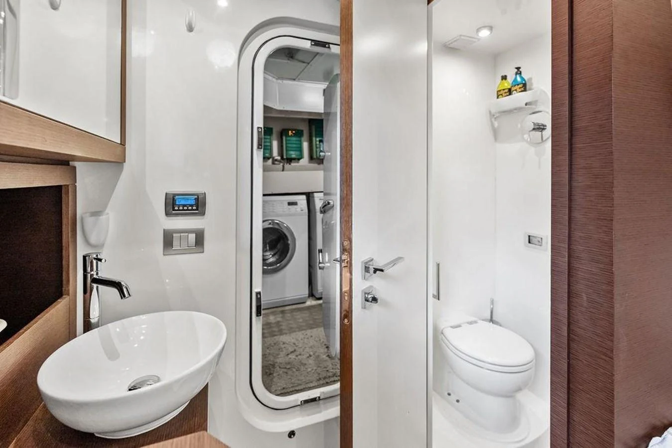 a bathroom with a sink toilet and a mirror aboard ELEVATION Yacht for Sale
