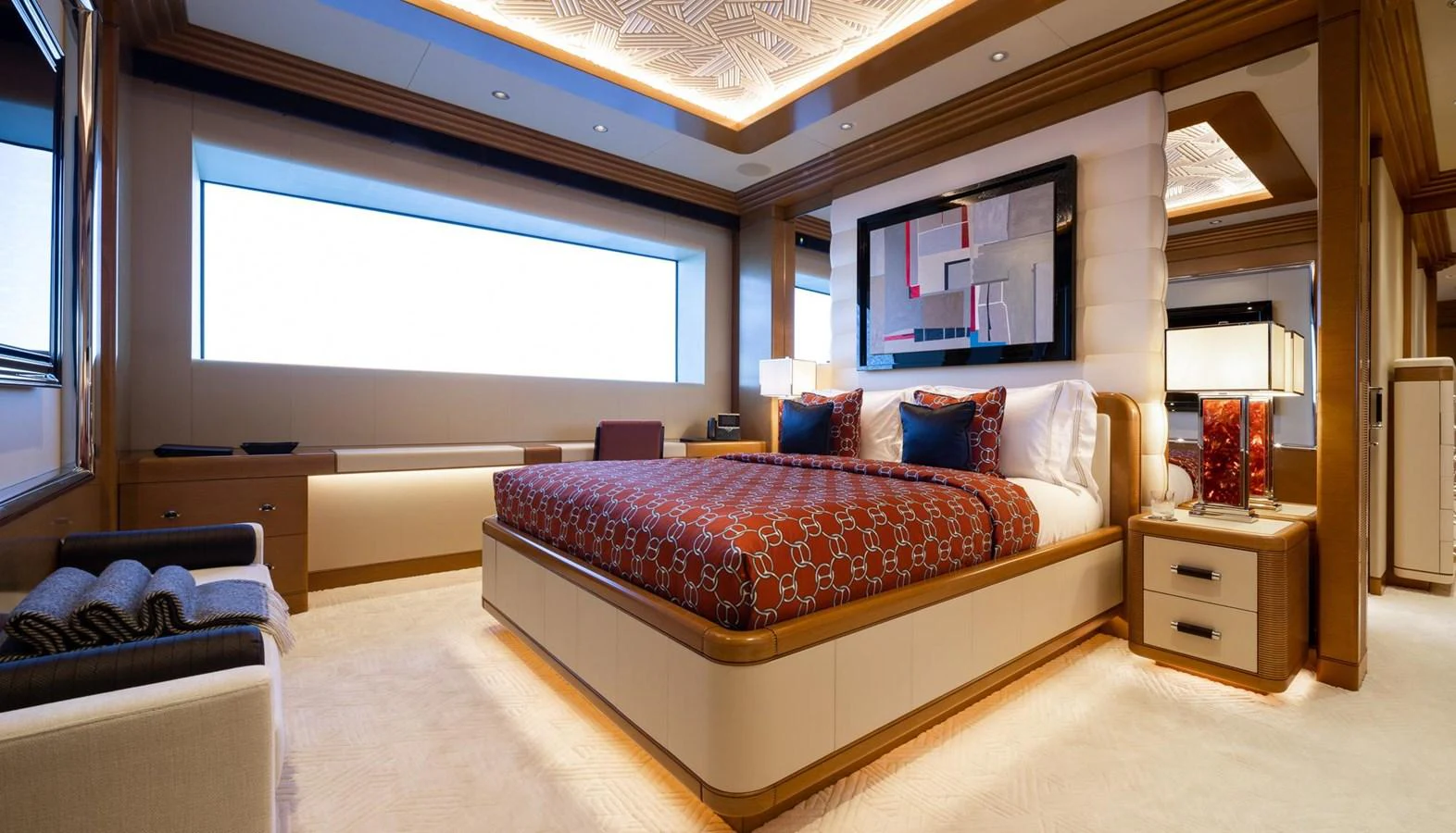 The master stateroom features a luxurious bed, elegant decor, and ample natural light. aboard LANA Yacht for Sale