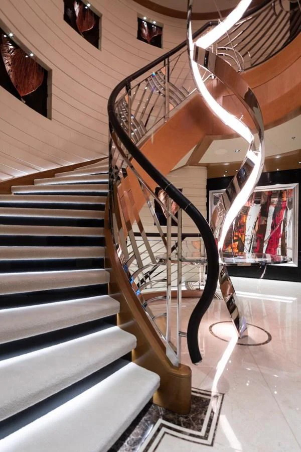 A luxurious spiral staircase with modern design elements and elegant lighting. aboard LANA Yacht for Sale
