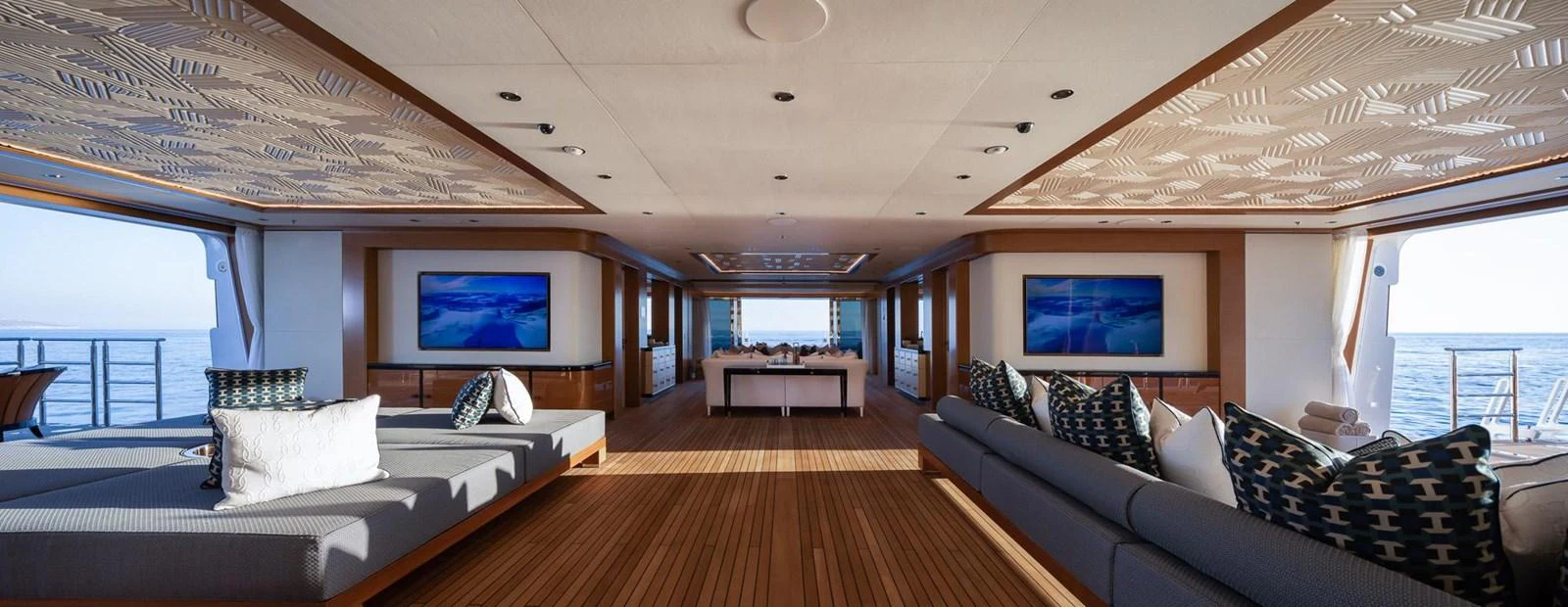 The spacious salon features elegant seating and panoramic ocean views. aboard LANA Yacht for Sale