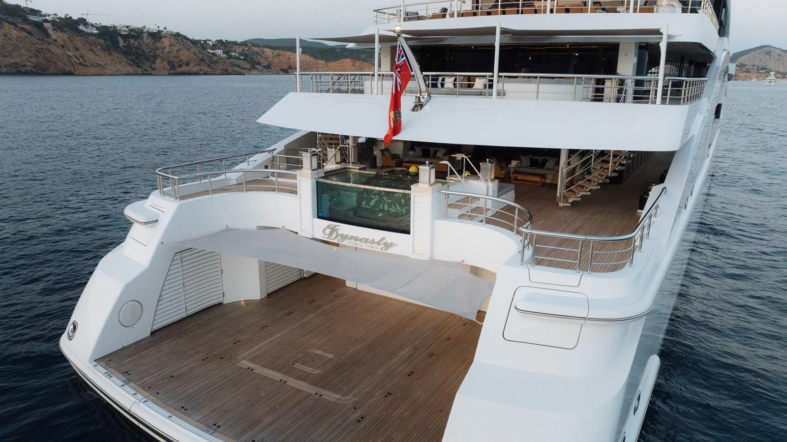 The yacht's aft deck features a spacious area with a jacuzzi and ample lounging space, perfect for relaxation. aboard I DYNASTY Yacht for Sale