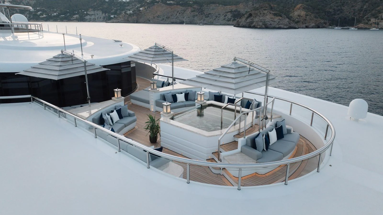 The sundeck features a luxurious lounging area with a central hot tub, surrounded by plush seating and shaded by elegant canopies. aboard I DYNASTY Yacht for Sale