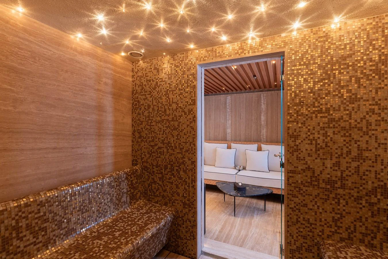 The yacht features a luxurious spa area with warm lighting and elegant mosaic tiles. aboard I DYNASTY Yacht for Sale