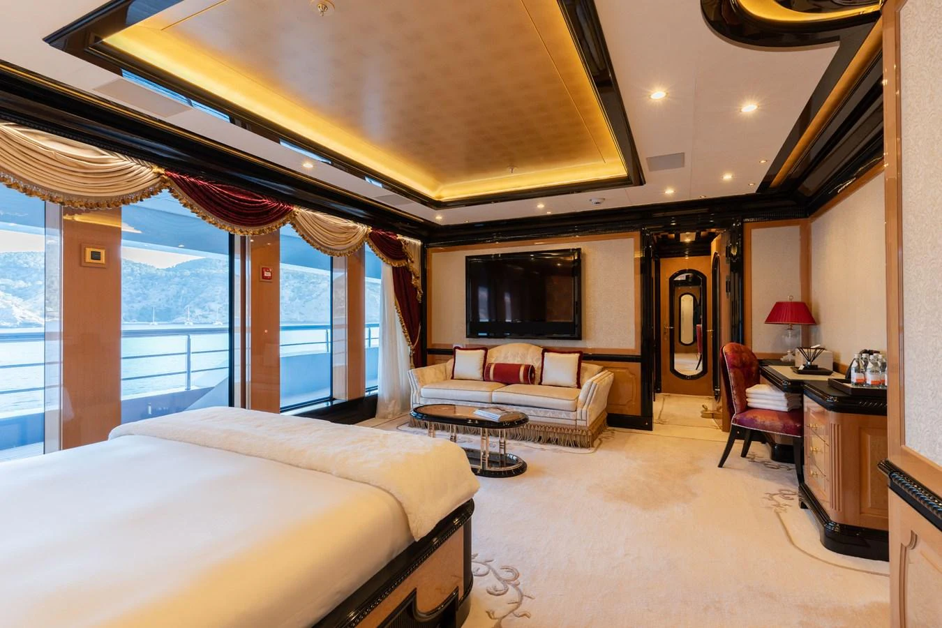 The master stateroom features luxurious furnishings and a stunning view through large windows. aboard I DYNASTY Yacht for Sale