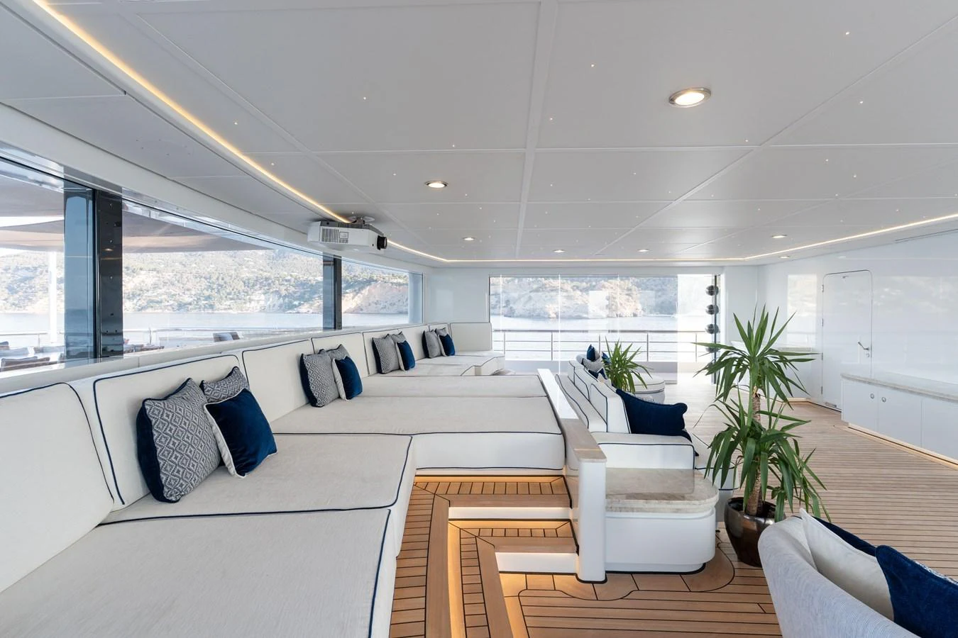 The yacht's lounge area features spacious seating with plush cushions and elegant decor, offering a serene view of the surrounding waters. aboard I DYNASTY Yacht for Sale