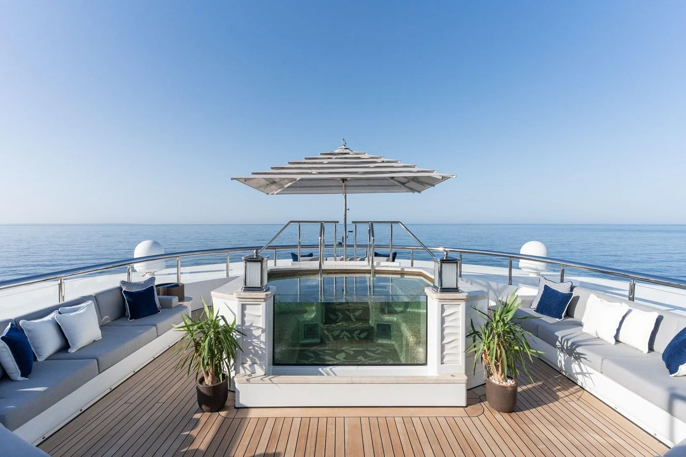 The sundeck features a luxurious hot tub surrounded by comfortable seating and panoramic ocean views. aboard I DYNASTY Yacht for Sale